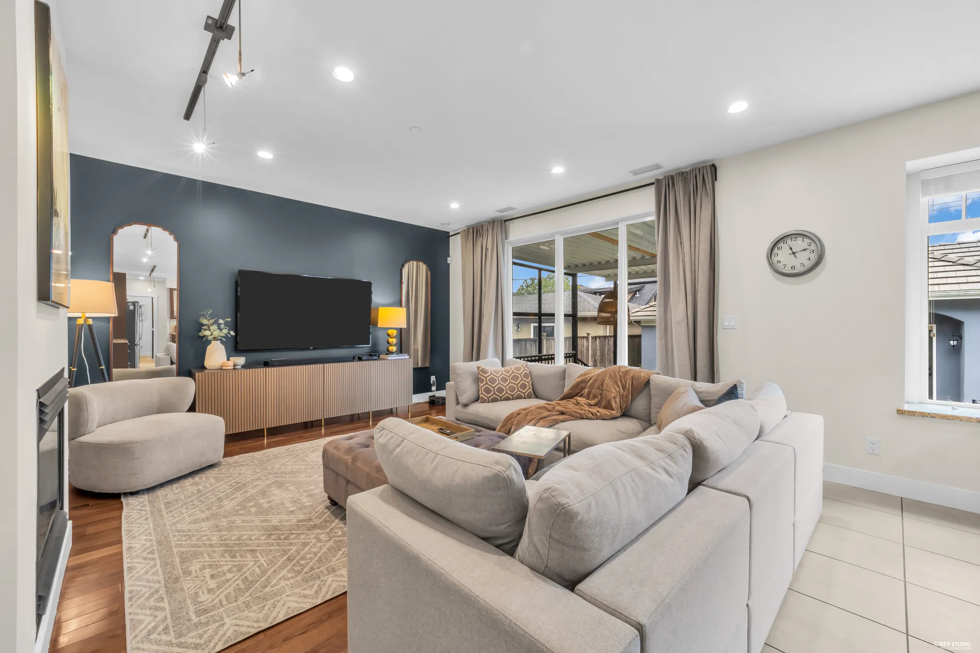 The family room toward its navy feature wall with the television