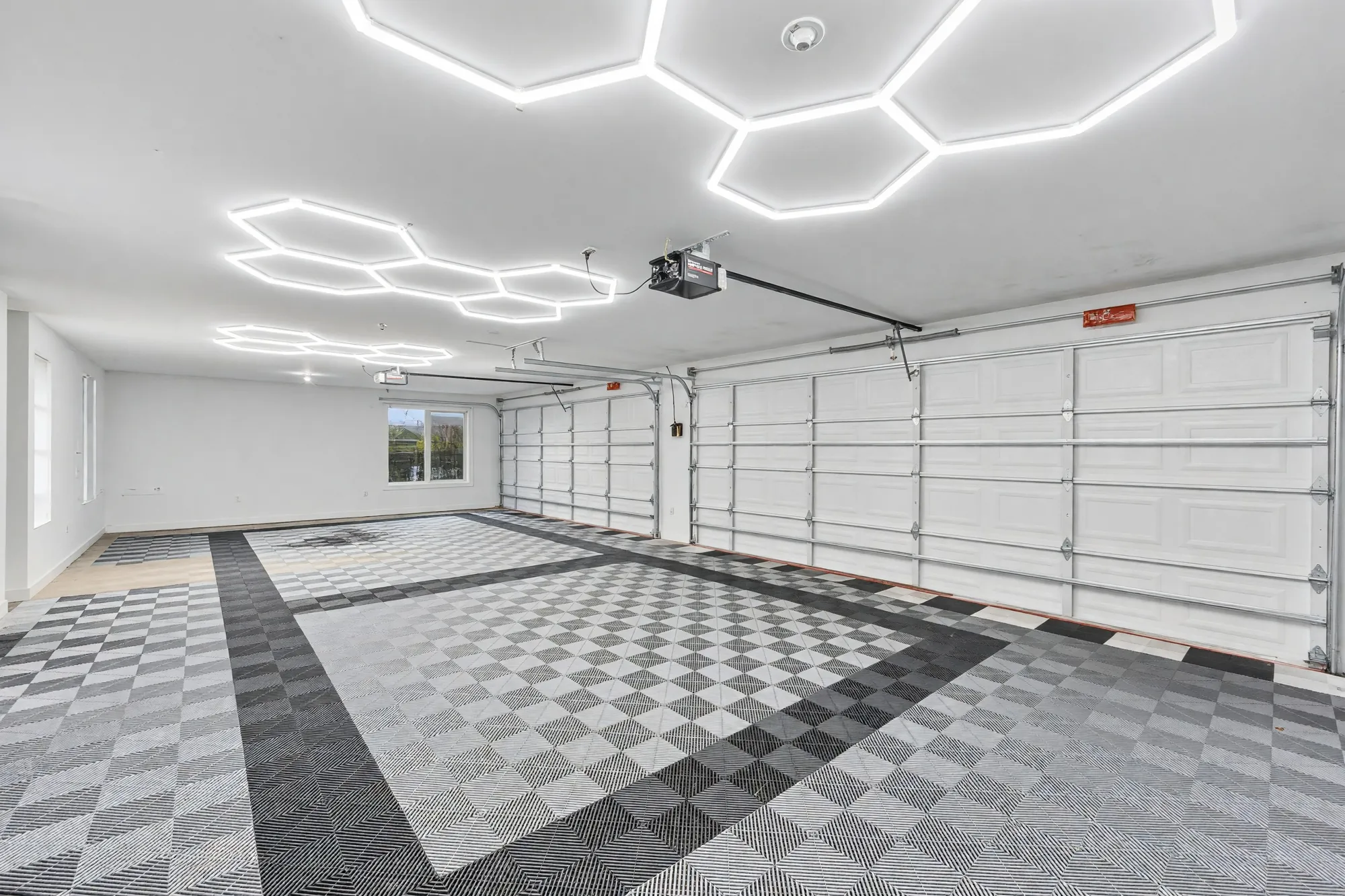 The garage toward its doors, the tiled floor in a checked pattern