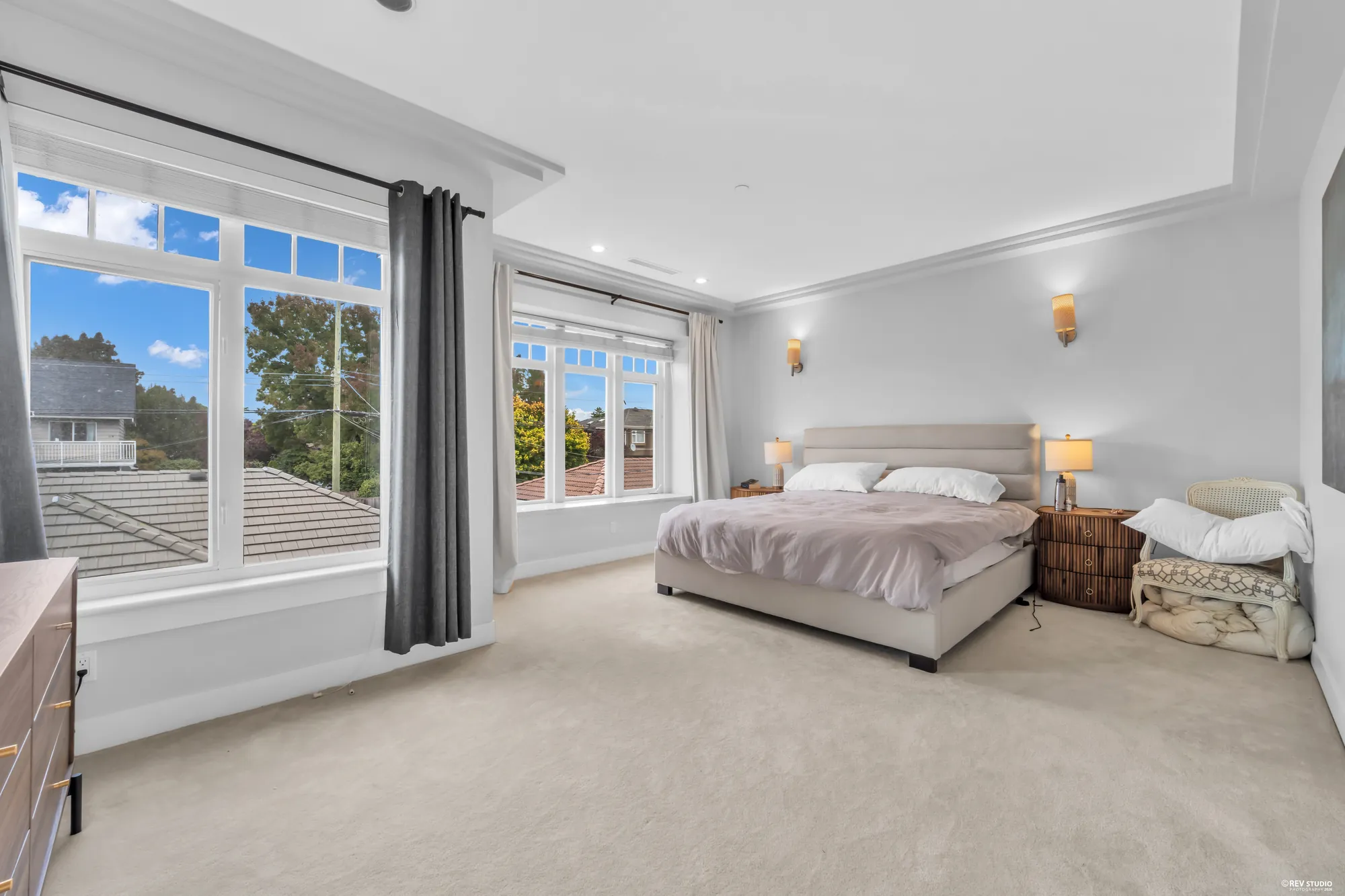 The primary bedroom from the door, the windows along the far wall